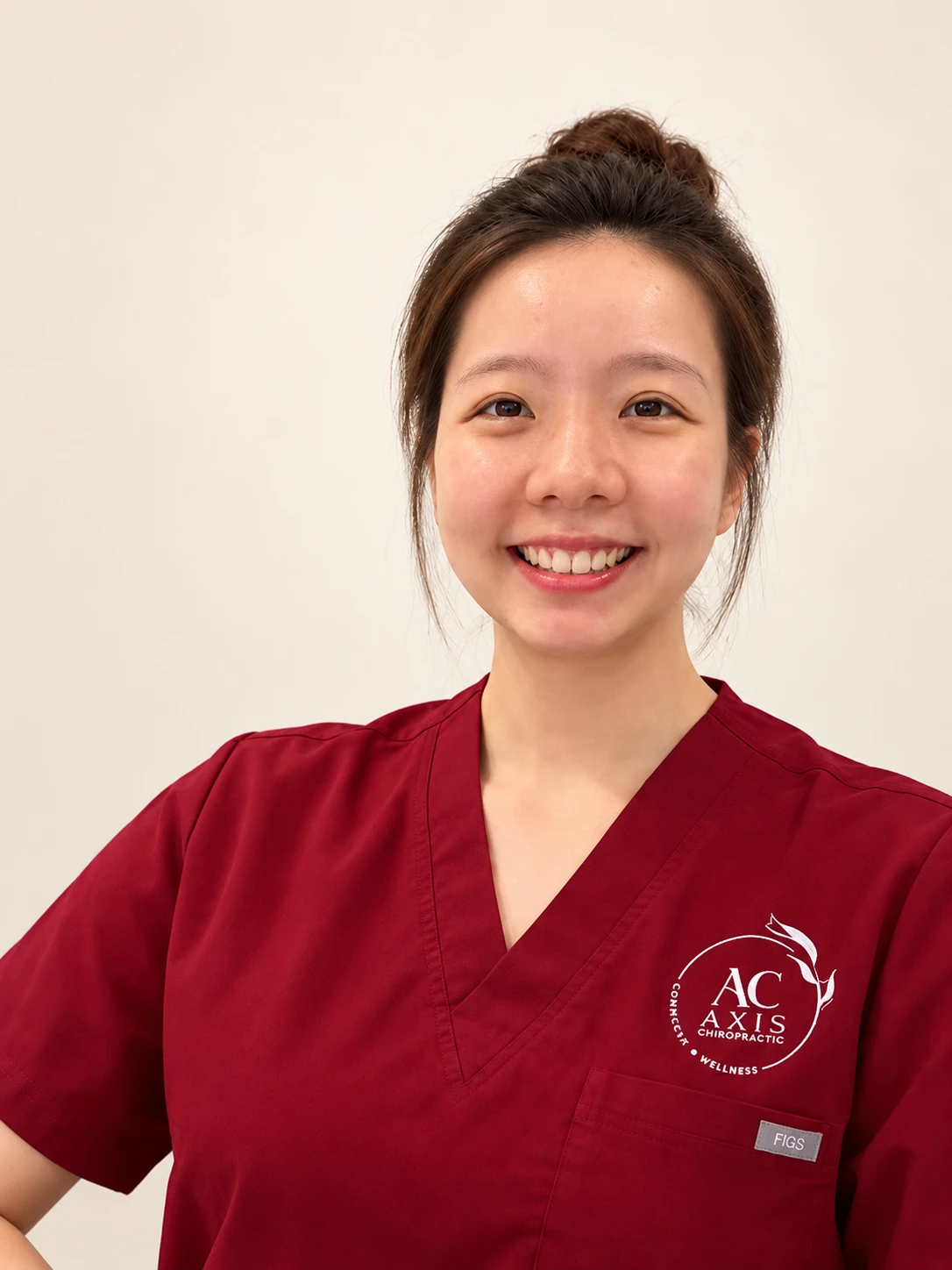 Dr Soo Si Min wearing burgundy red scrubs